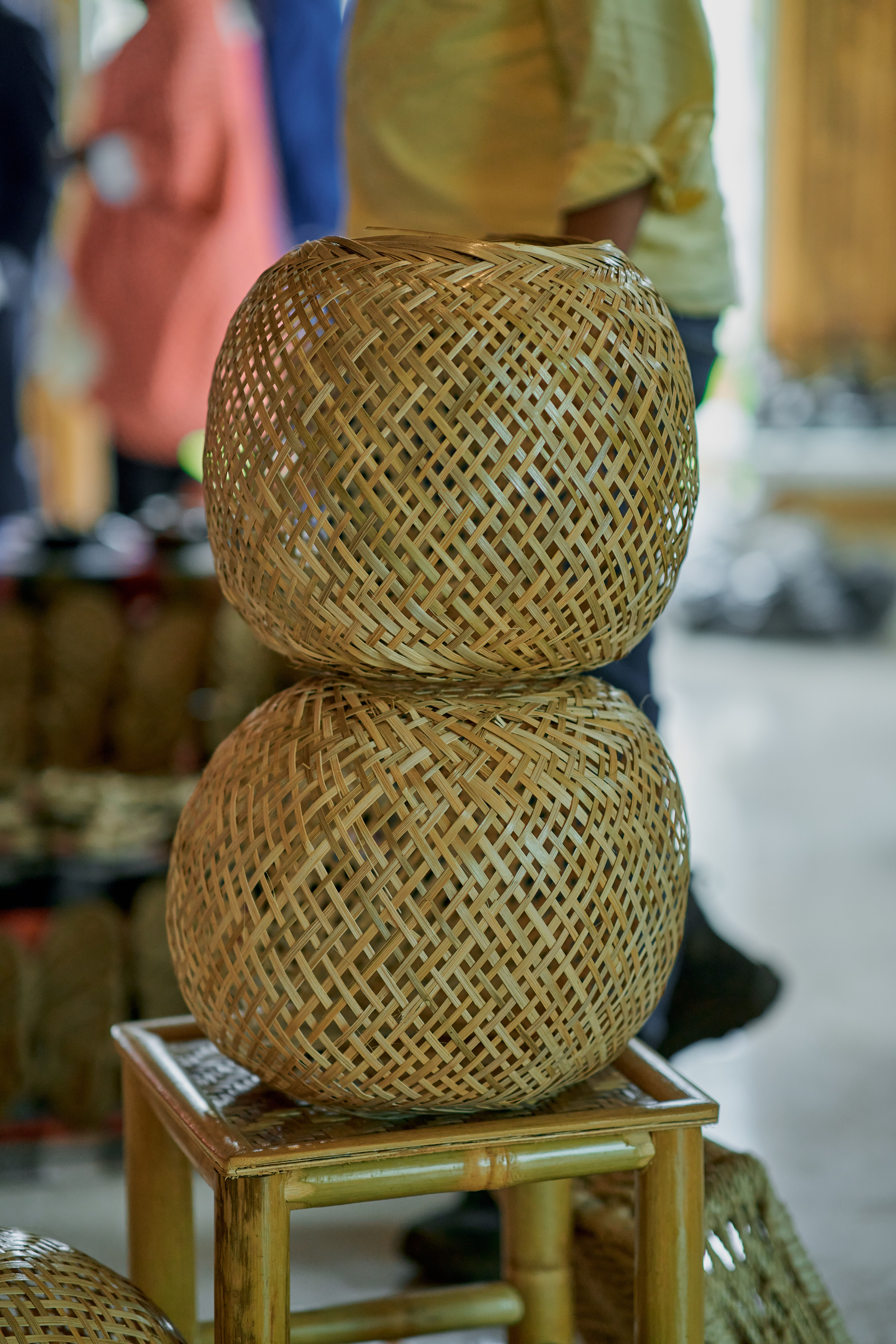 Stacked handwoven bamboo baskets at a craft market, representing eco-friendly business ideas in India