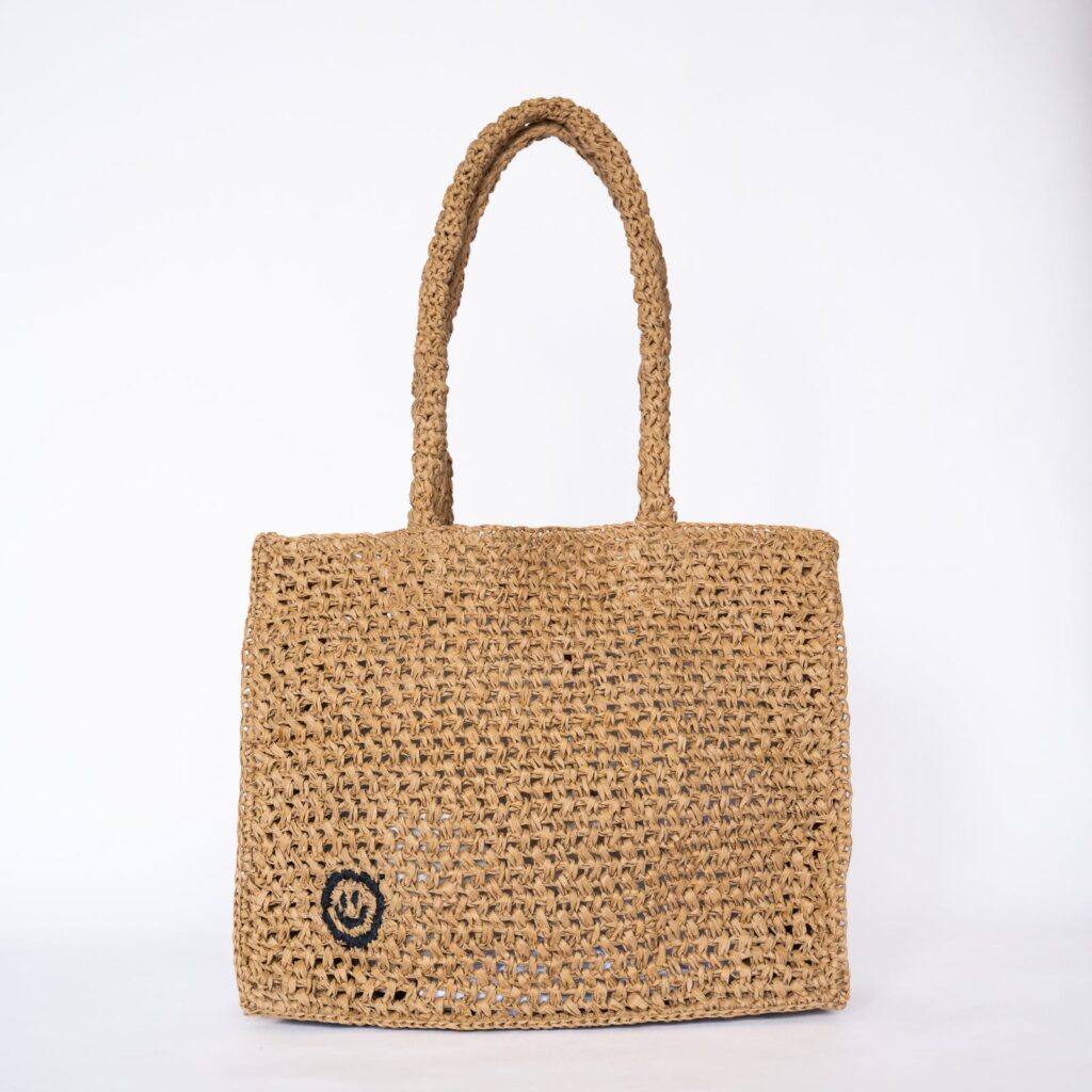 Handwoven raffia tote bag, a sustainable natural fibre accessory