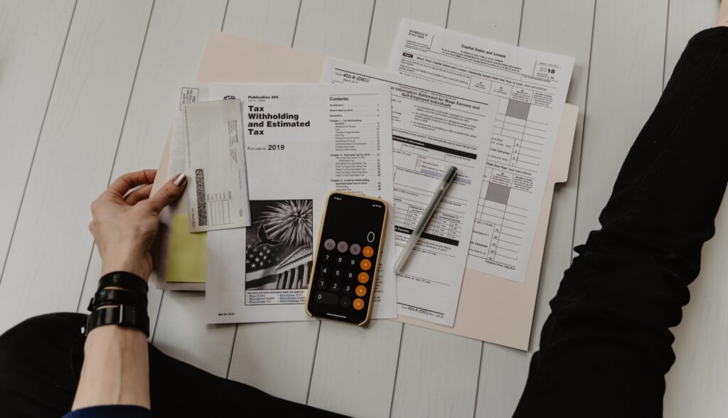 Tax and financial documents with a calculator prepared for a carbon accounting audit review