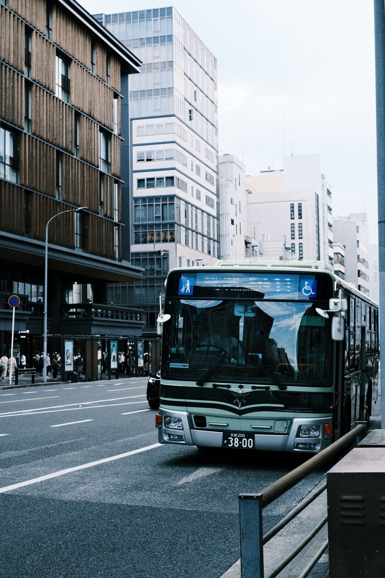A city bus on a busy urban street representing public transport and clean mobility
