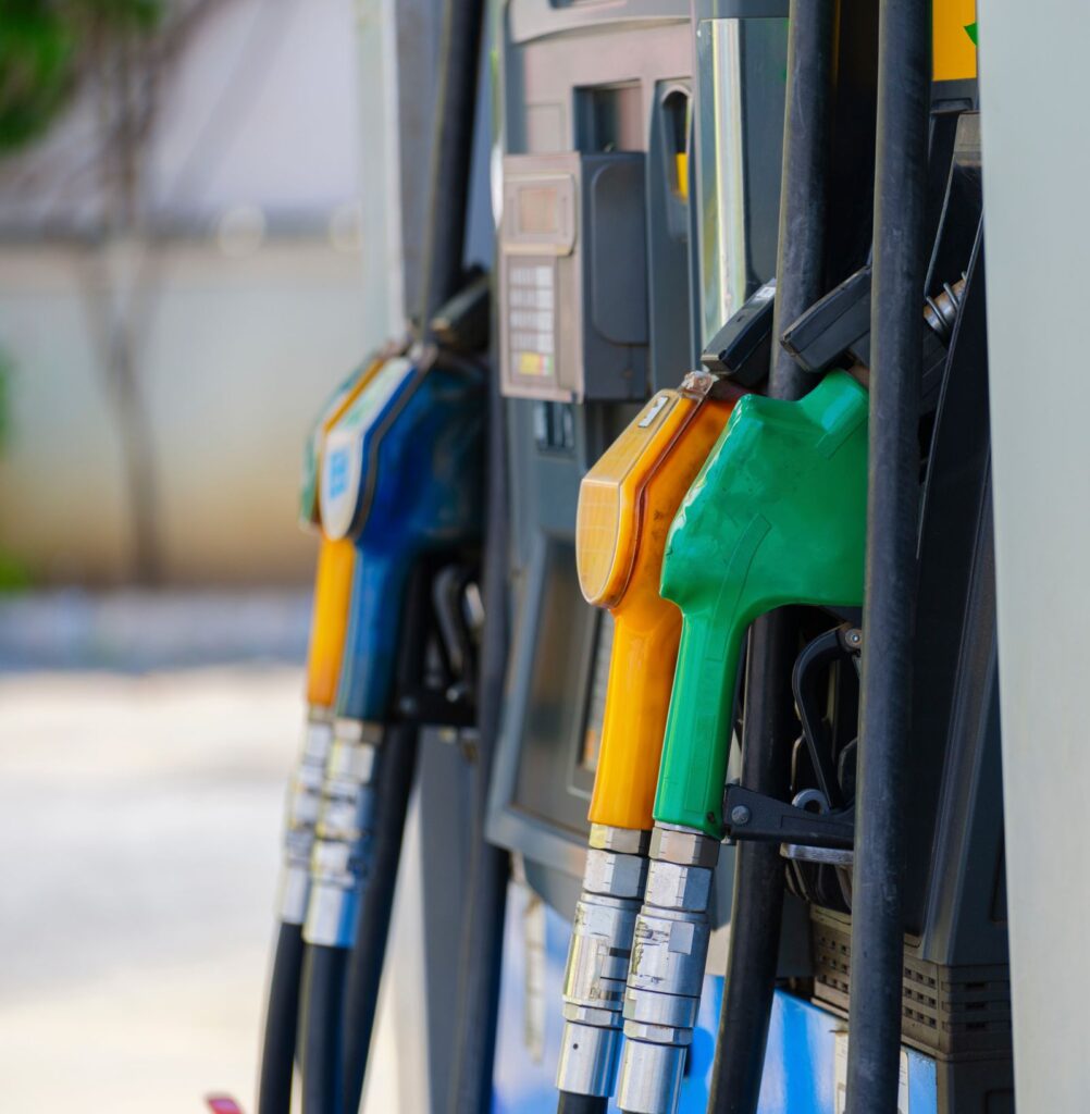 Close-up of colourful fuel pump nozzles at a petrol station