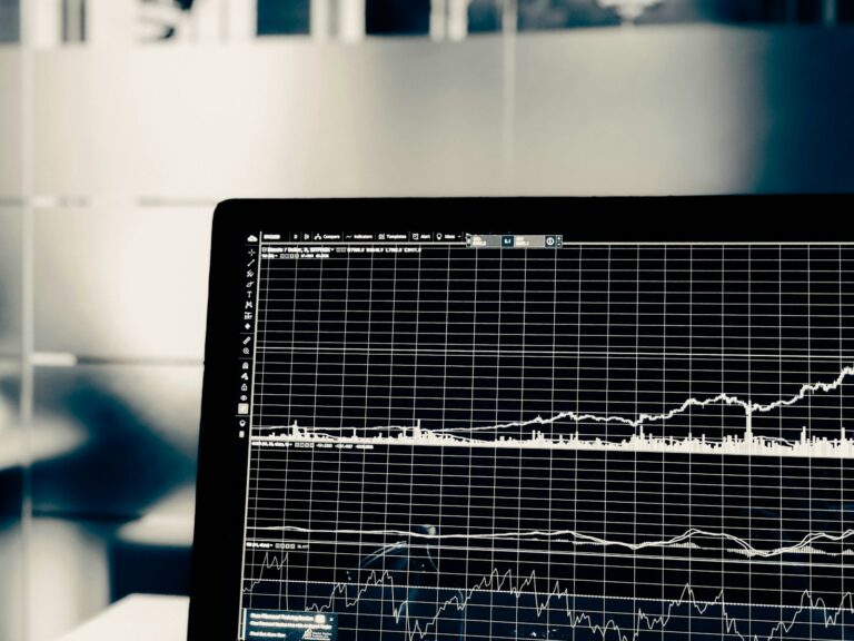 A computer screen displaying live data charts, representing the shift toward real-time carbon accounting