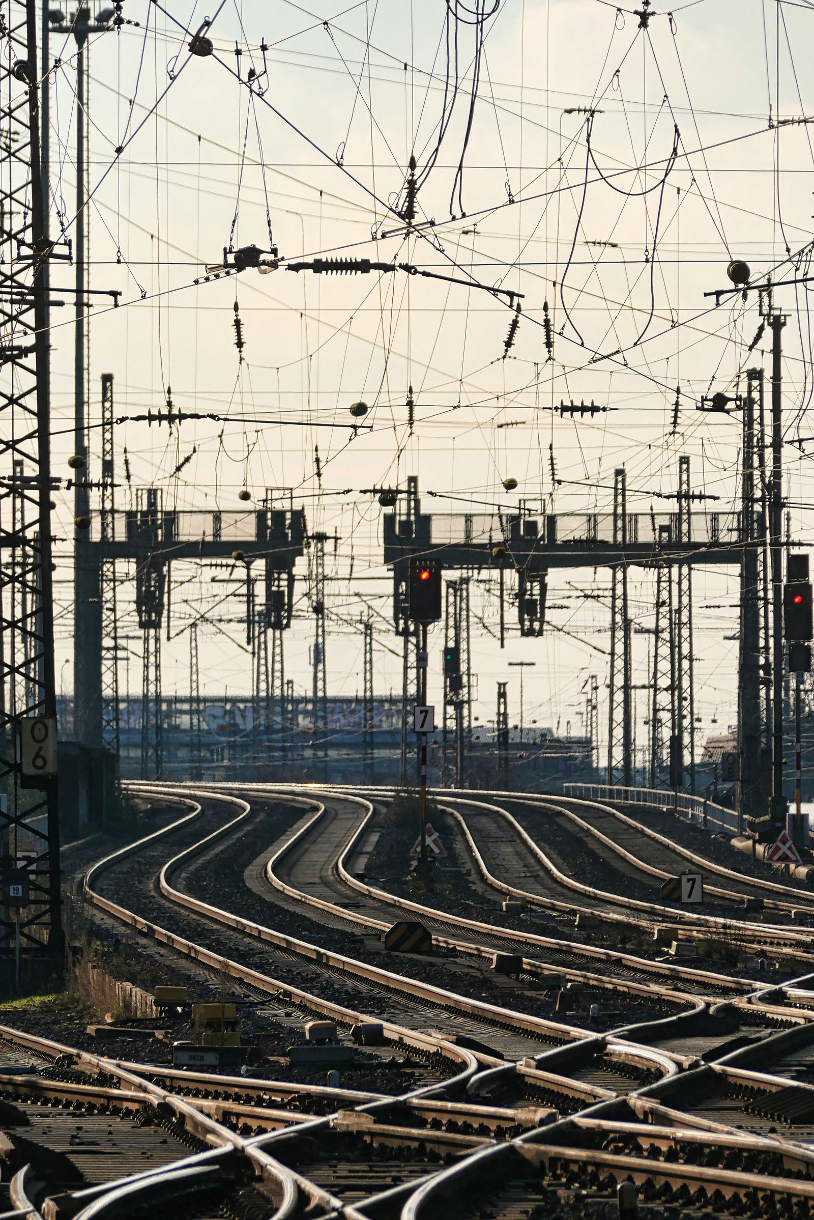 Railway tracks with overhead electrification wires and signal infrastructure