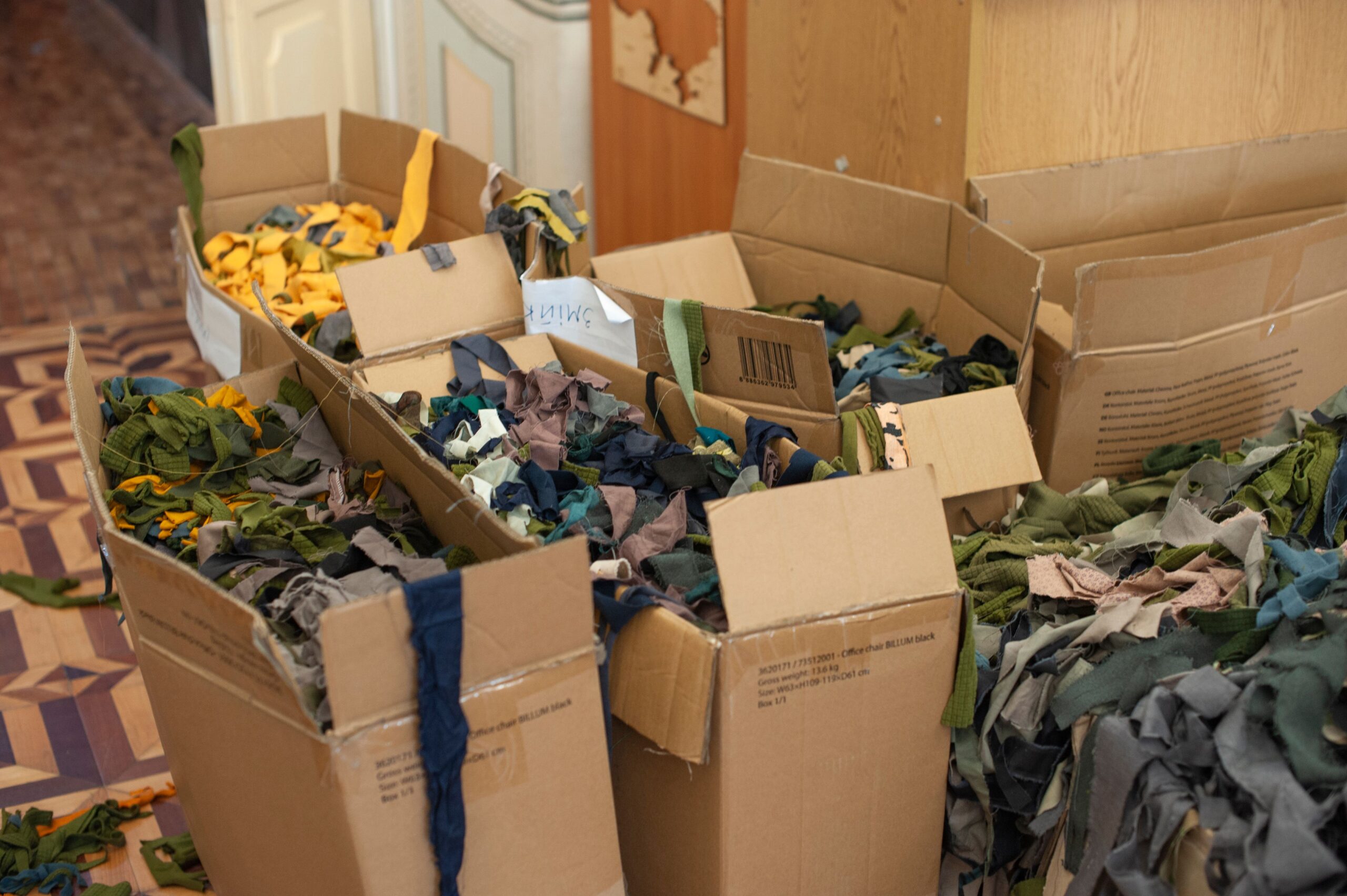 Sorted colourful textile waste scraps in boxes ready for recycling