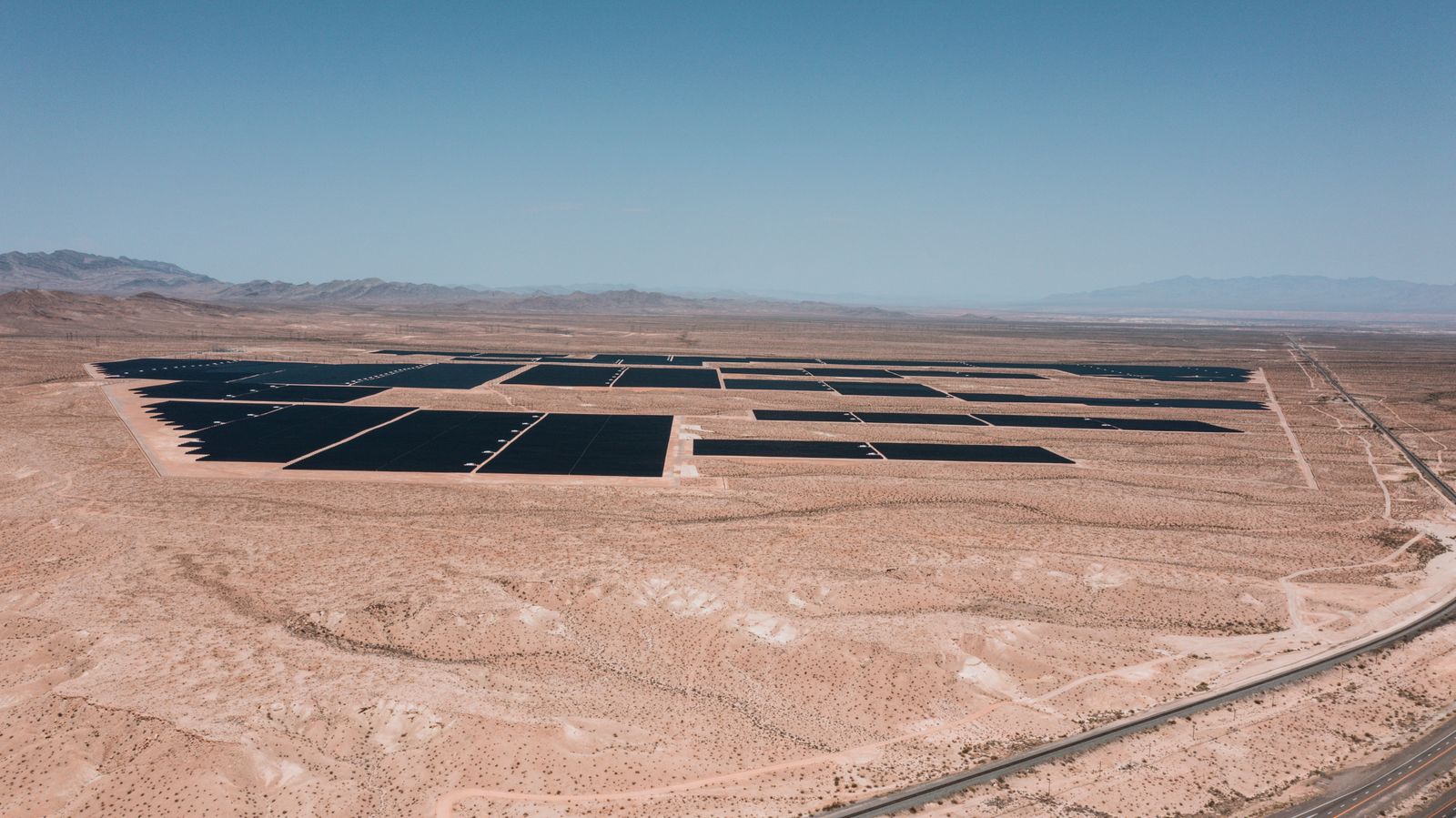 Rows of solar panels at a large utility-scale solar park in India