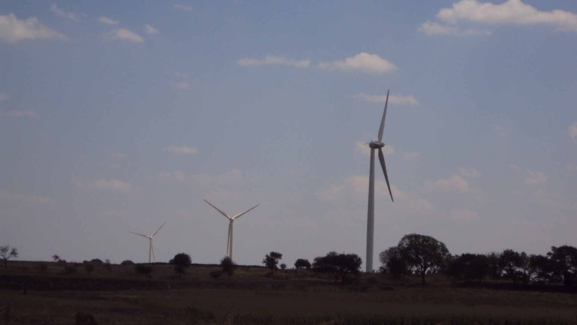 Wind turbines on a hillside generating clean electricity in India