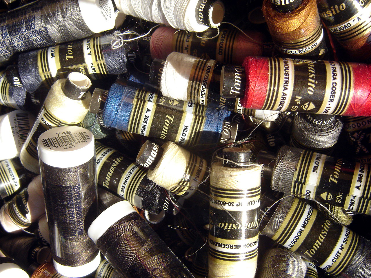 Rows of mercerized organic cotton thread reels in a textile mill