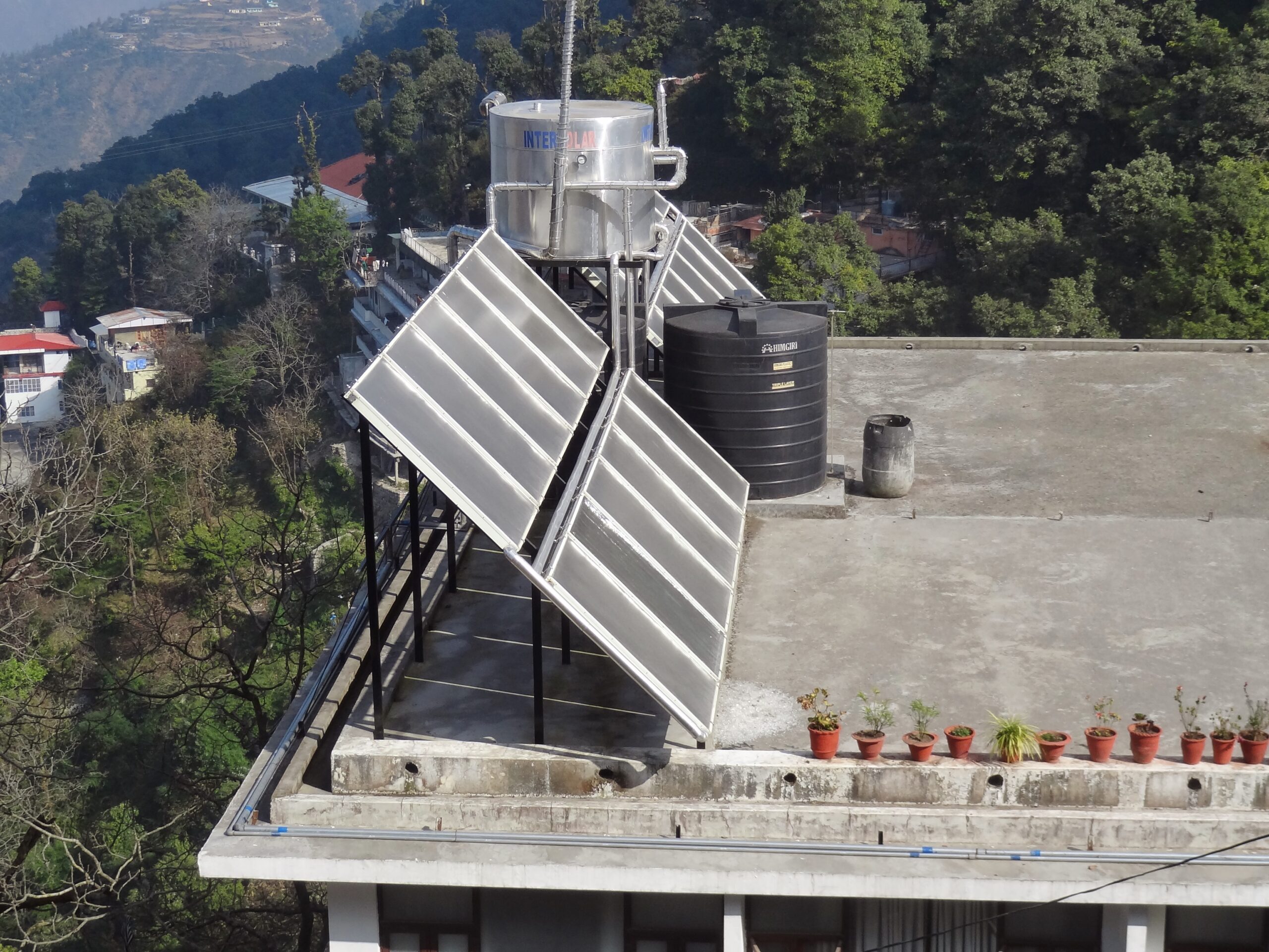 Flat plate collector (FPC) solar water heater with insulated storage tank installed on a residential rooftop in Mussoorie, Uttarakhand