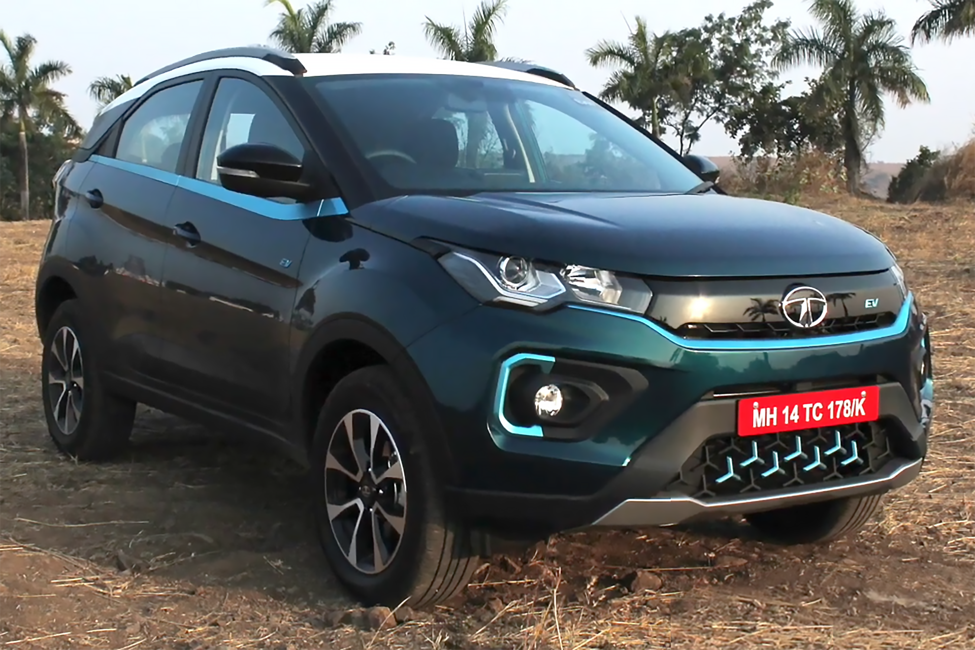 Tata Nexon EV, an Indian-made electric SUV, parked outdoors with palm trees in the background
