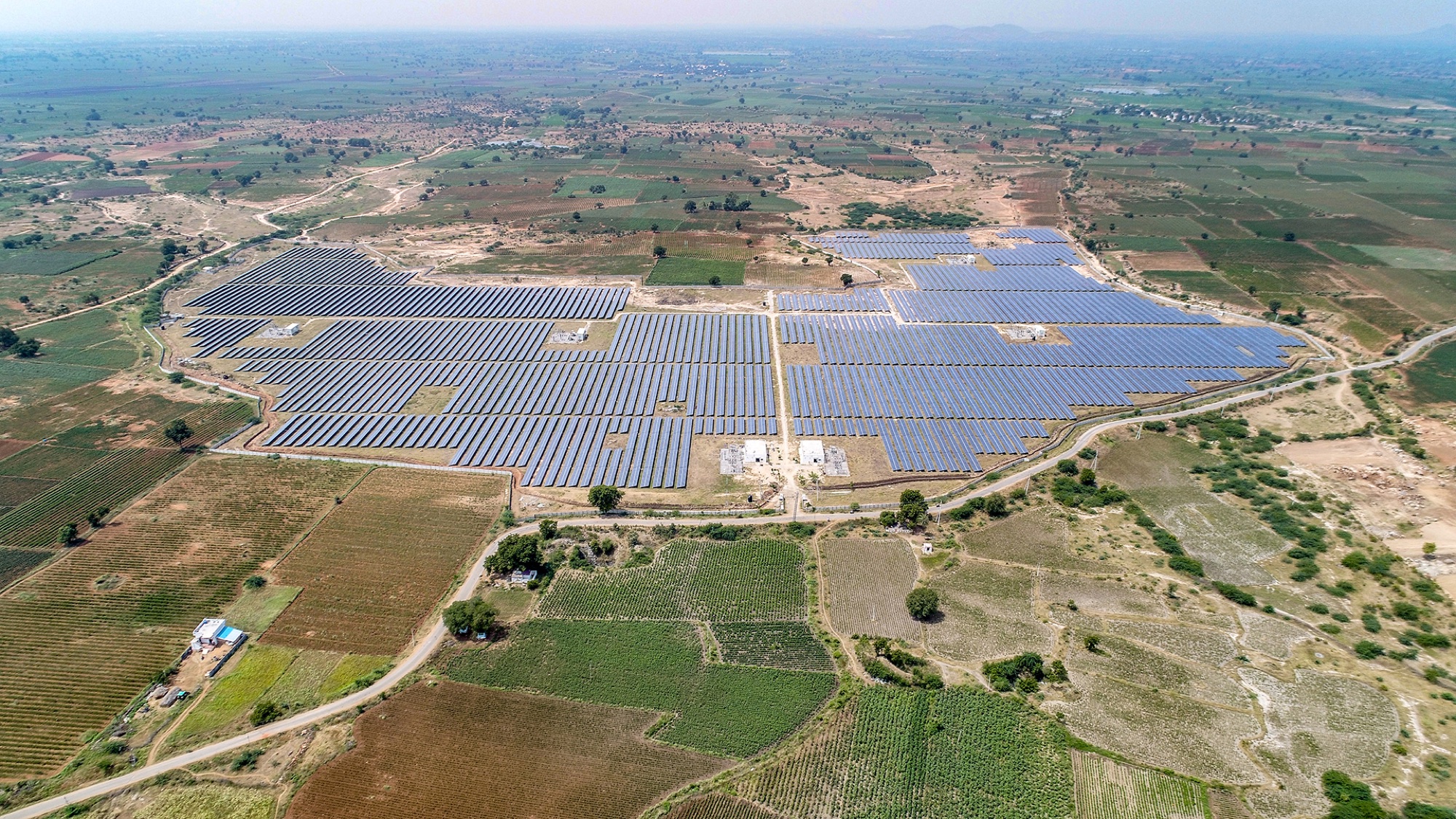 Rows of solar panels at a commercial solar power plant in Telangana, India