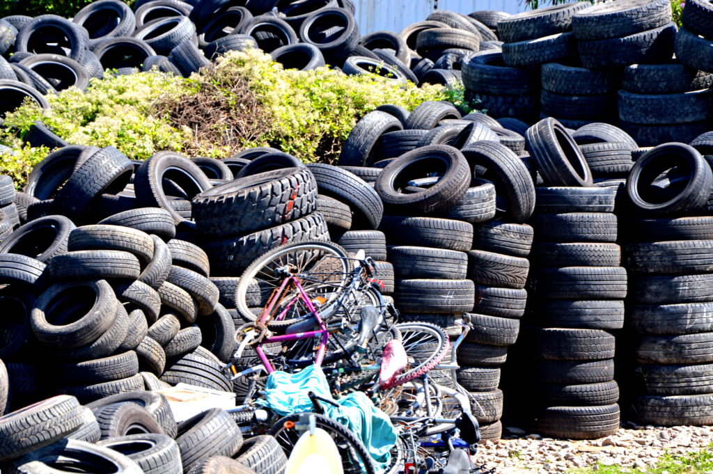 Large stacks of scrap tyres waiting to be processed at a recycling facility