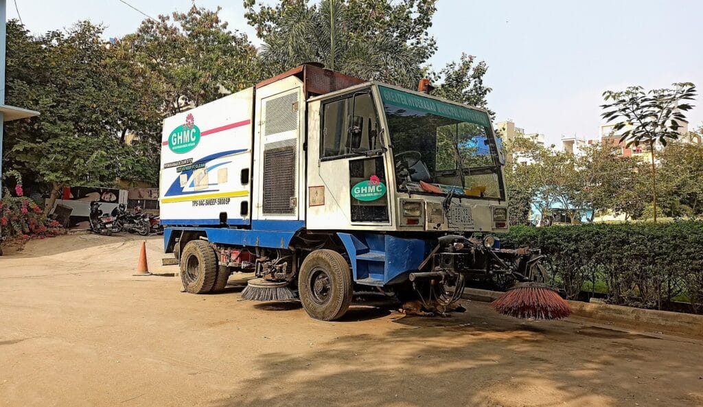 Mechanical road sweeping machine used by a city corporation to control road dust in Hyderabad