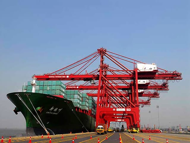 Container ship and cranes at Jawaharlal Nehru Port, Navi Mumbai, India